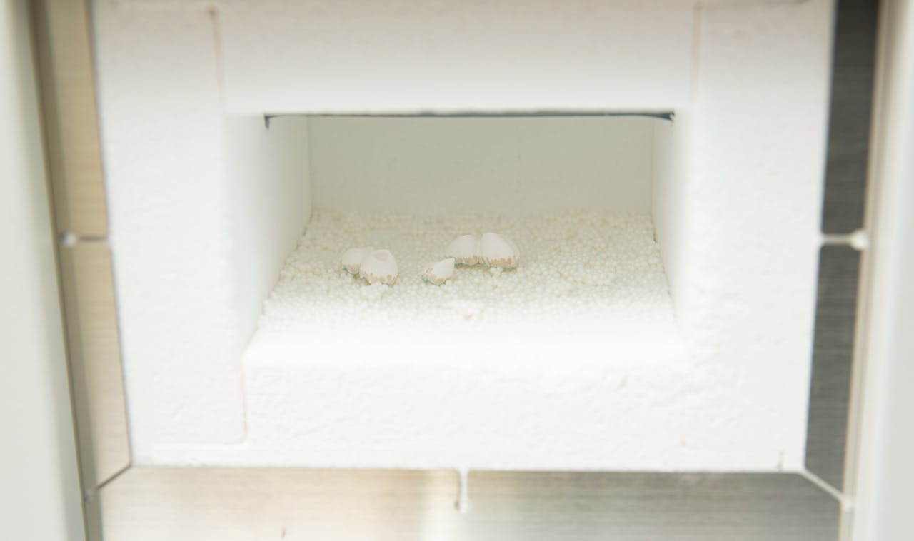 about-01 Dental lab furnace with dentures inside for production of prosthetic teeth.